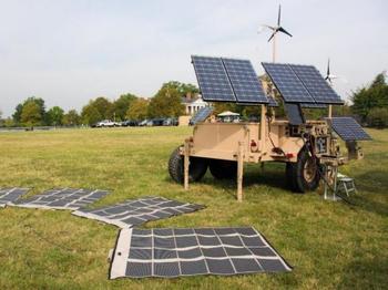 Solar panels on a grassy field collecting sun light for energy.